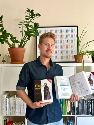 Sebastian Raschka holding Build a Reasoning Model (From Scratch)